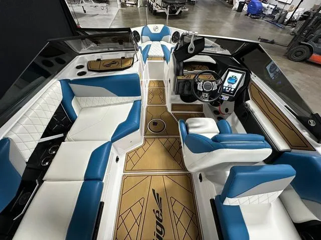 Slide: The Image of 2022 Tigé Z1 boat interior with blue and white seating, modern dashboard, and wood accents. - 11