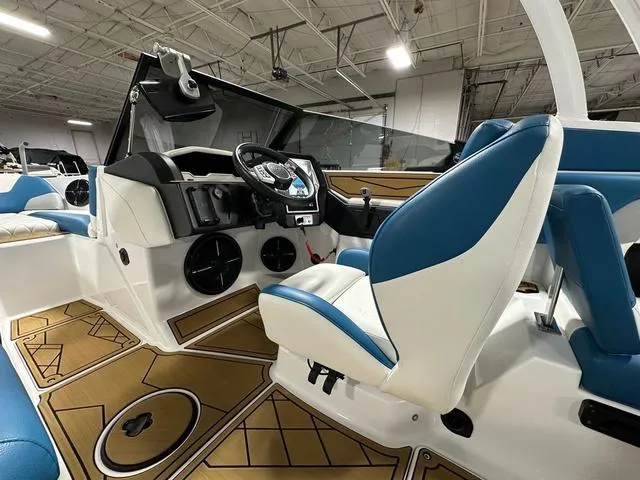 Slide: The Image of 2022 Tigé Z1 boat interior with blue and white seating, modern dashboard, and stylish flooring. - 12