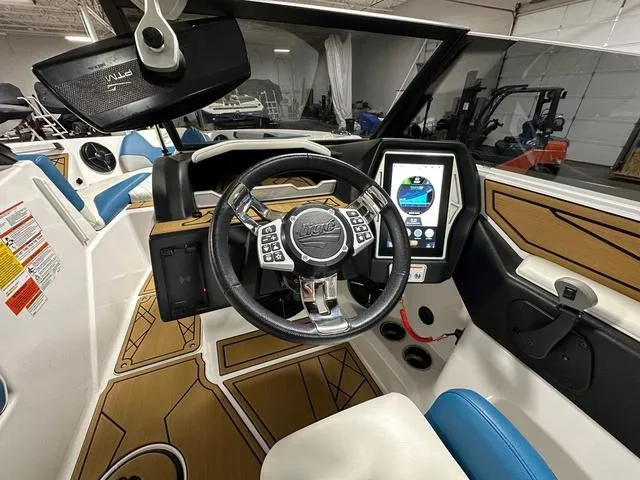 Slide: The Image of 2022 Tigé Z1 boat interior with modern steering wheel and touchscreen display. - 13