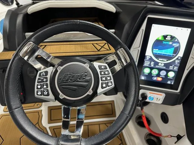 Slide: The Image of Steering wheel and dashboard of 2022 Tigé Z1 boat with touchscreen display. - 14