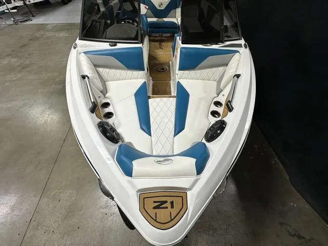 Slide: The Image of 2022 Tigé Z1 boat with blue and white interior, docked indoors. - 17