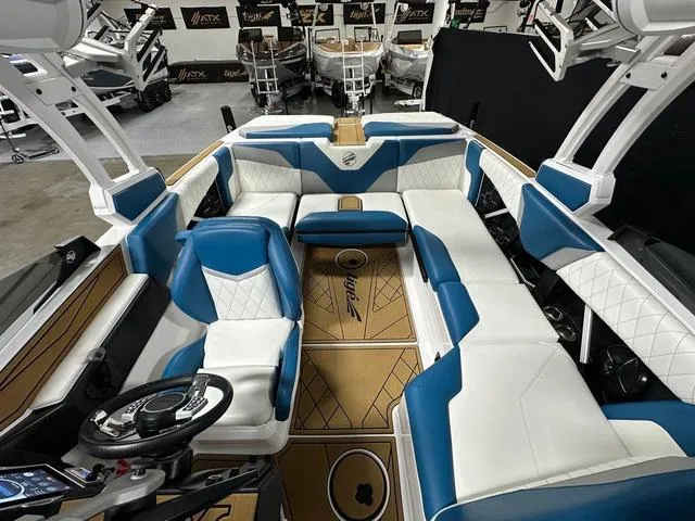 Slide: The Image of 2022 Tigé Z1 boat interior with blue and white seating, modern design, and spacious layout. - 18