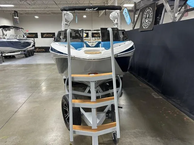 Slide: The Image of 2022 Tigé Z1 boat on trailer in showroom with ladder access. - 3