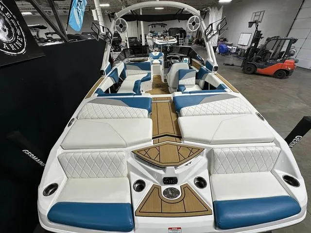 Slide: The Image of 2022 Tigé Z1 boat interior with white and blue seating, wood accents, and modern design. - 6