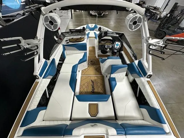 Slide: The Image of 2022 Tigé Z1 boat interior with blue and white seating, advanced dashboard, and speakers. - 8