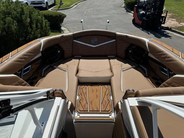 Slide: The Image of 2025 Tigé 23ZX Ultre boat interior with luxurious tan seating and wood accents. - 12
