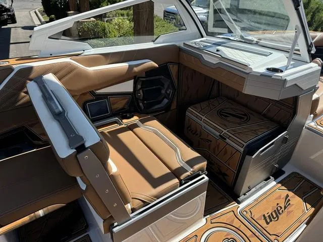 Slide: The Image of 2025 Tigé 23ZX Ultre boat interior with tan leather seats and modern dashboard. - 13