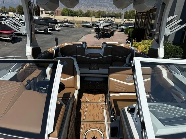 Slide: The Image of 2025 Tigé 23ZX Ultre boat interior with luxurious brown seating and modern design. - 14