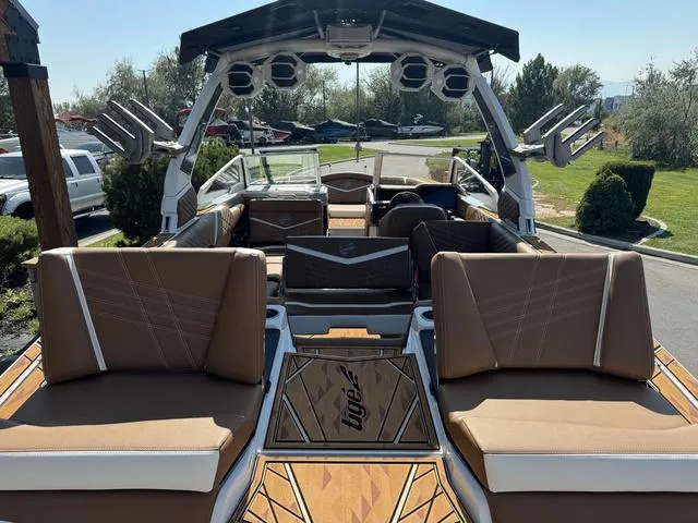 Slide: The Image of 2025 Tigé 23ZX Ultre boat interior with tan seating and sleek design. - 15