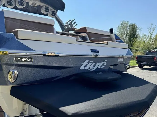Slide: The Image of 2025 Tigé 23ZX Ultre boat, rear view, showcasing sleek design and branding. - 5