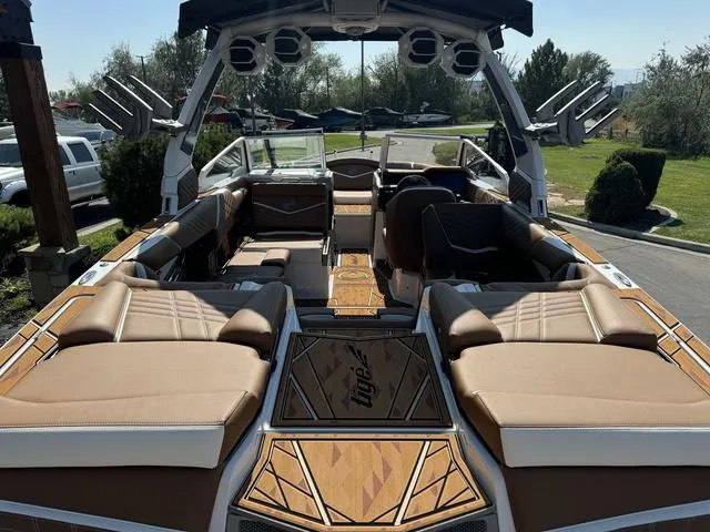 Slide: The Image of 2025 Tigé 23ZX Ultre boat interior with tan seating and advanced audio system. - 9