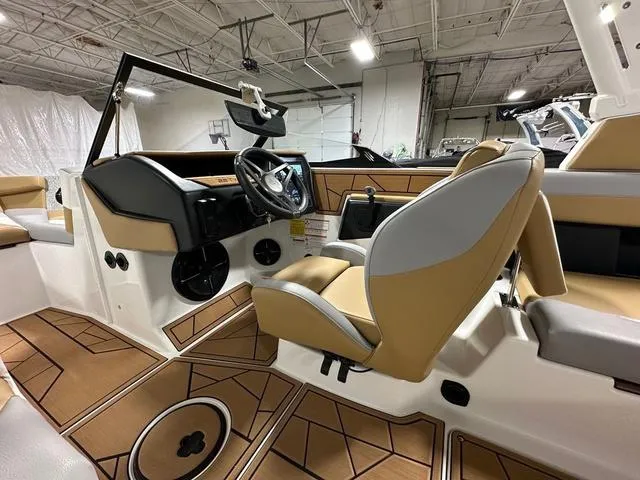 Slide: The Image of 2023 ATX Boats 22 TYPE-S interior with tan and gray seating, modern dashboard, and spacious layout. - 12