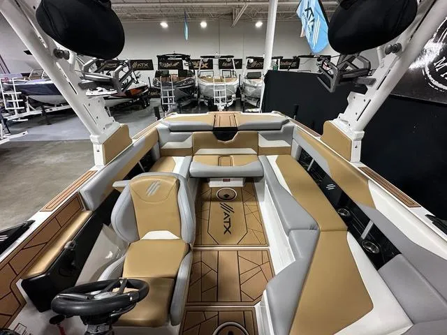 Slide: The Image of 2023 ATX Boats 22 TYPE-S interior with tan and gray seating in showroom. - 18
