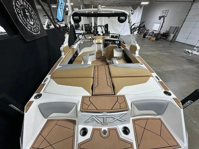 Slide: The Image of 2023 ATX Boats 22 TYPE-S interior with tan and white seating in a showroom. - 6