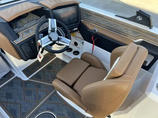Slide: The Image of 2025 Tigé Z3 boat interior with modern dashboard and luxurious brown seating. - 10