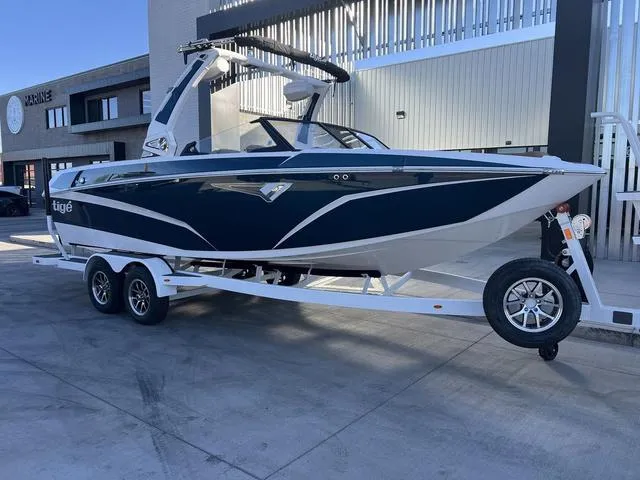 Slide: The Image of 2025 Tigé Z3 boat on trailer, sleek design, parked outdoors. - 2