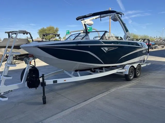 Slide: The Image of 2025 Tigé Z3 boat on trailer, parked outdoors under clear blue sky. - 4