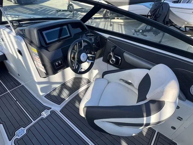 Slide: The Image of 2020 Monterey MX6 SURF boat interior with steering wheel and captain's seat. - 11