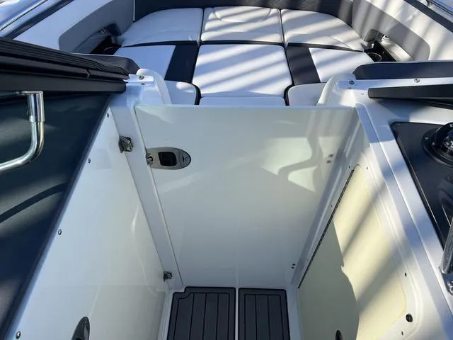 Slide: The Image of 2020 Monterey MX6 SURF boat interior with seating and storage area. - 13