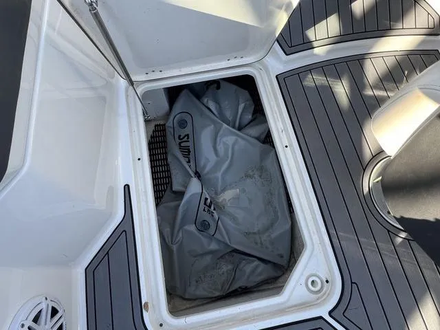 Slide: The Image of Storage compartment of 2020 Monterey MX6 SURF boat with gray bag inside. - 18