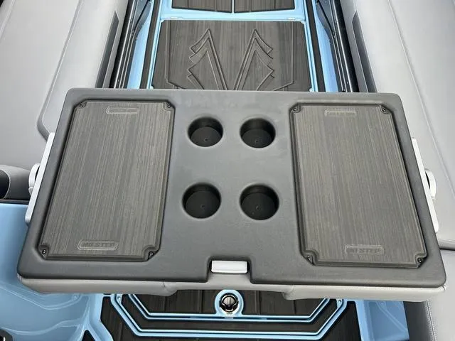 Slide: The Image of 2025 Supra SE 575 boat interior with cup holders and sleek design. - 14