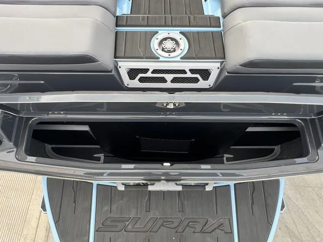 Slide: The Image of 2025 Supra SE 575 boat interior with storage compartment and sleek design. - 16
