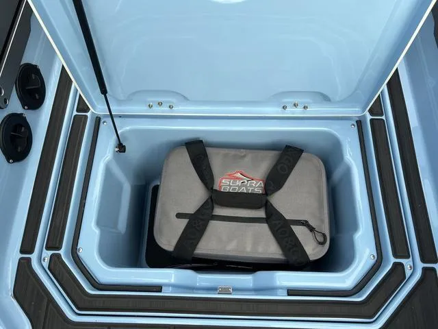 Slide: The Image of Storage compartment of 2025 Supra SE 575 boat with a Supra Boats bag inside. - 4