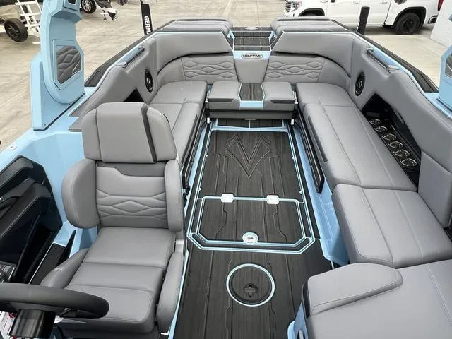 Slide: The Image of 2025 Supra SE 575 boat interior with gray seating and sleek design. - 8