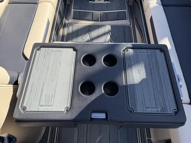 Slide: The Image of 2025 Supra SL 400 interior with a foldable table and cup holders. - 14