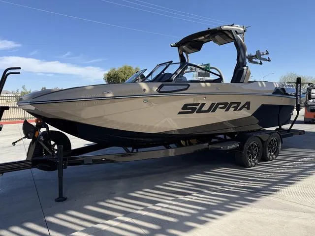 Slide: The Image of 2025 Supra SL 400 boat on trailer, sleek design, parked outdoors. - 4
