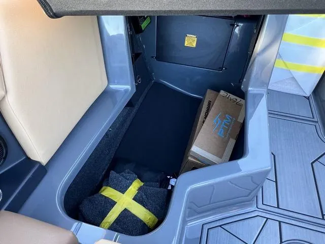 Slide: The Image of 2025 ATX Boats 24 TYPE-S storage compartment with boxes and wrapped items. - 13