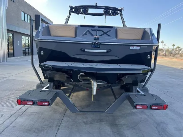 Slide: The Image of 2025 ATX Boats 24 TYPE-S, rear view, parked on concrete, showcasing swim platform and wakeboard tower. - 7