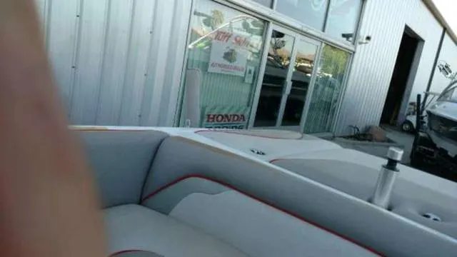 Slide: The Image of 2009 Centurion Elite V C4 Air Warrior boat near a dealership building. - 18