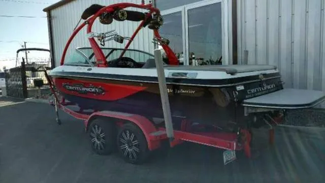 Slide: The Image of 2009 Centurion Elite V C4 Air Warrior boat on trailer, parked outside a building. - 3
