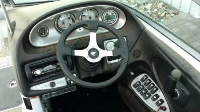 Slide: The Image of 2009 Centurion Elite V C4 Air Warrior boat dashboard with steering wheel and control panel. - 9