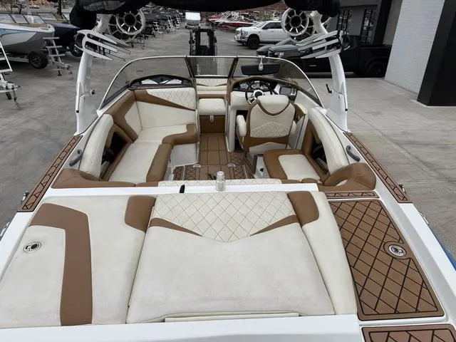 Slide: The Image of 2014 Tigé RZ2 boat interior with beige and brown seating, featuring a modern design. - 10