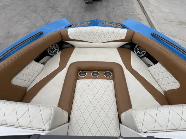 Slide: The Image of 2014 Tigé RZ2 boat interior with white and brown diamond-stitched upholstery. - 11