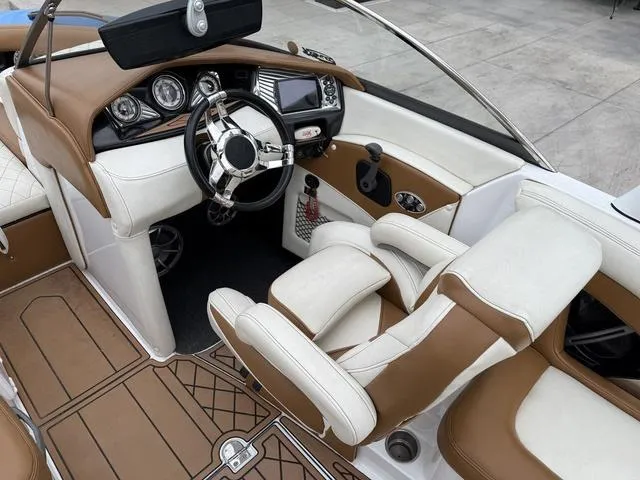 Slide: The Image of 2014 Tigé RZ2 boat interior with brown and white leather seats and modern dashboard. - 12