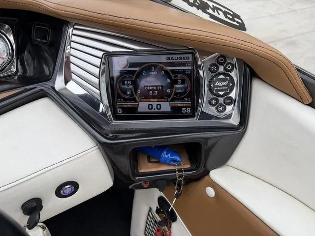 Slide: The Image of Dashboard of a 2014 Tigé RZ2 boat with digital gauges and controls. - 15