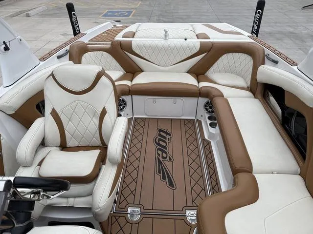 Slide: The Image of 2014 Tigé RZ2 boat interior with luxurious brown and white seating and custom flooring. - 9