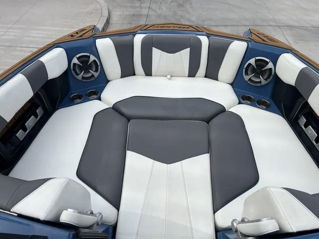 Slide: The Image of 2021 Malibu 23 MXZ boat interior with stylish seating and cup holders. - 10