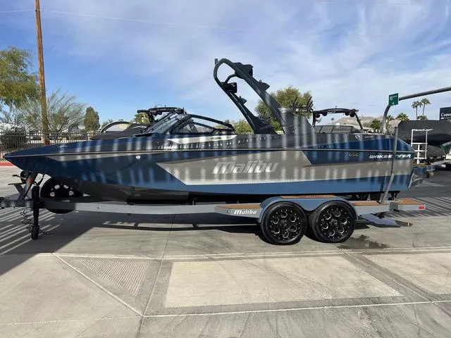 Slide: The Image of 2021 Malibu 23 MXZ boat on trailer, parked outdoors, side view. - 5