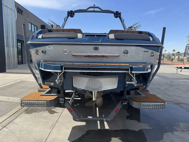 Slide: The Image of 2021 Malibu 23 MXZ boat rear view with swim platform and propeller. - 7
