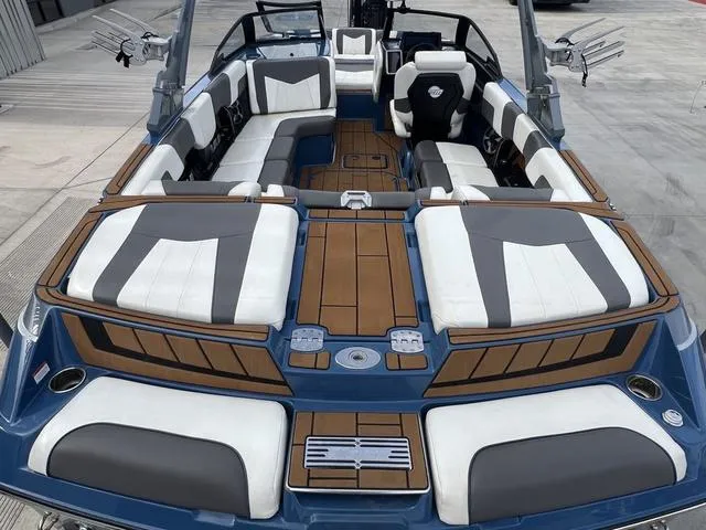 Slide: The Image of 2021 Malibu 23 MXZ boat interior with luxurious seating and modern design. - 9