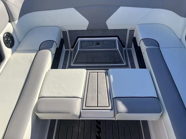 Slide: The Image of 2023 Moomba Max boat interior with cushioned seating and sleek design. - 13