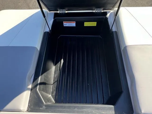 Slide: The Image of 2023 Moomba Max storage compartment with open lid, showcasing spacious interior. - 14