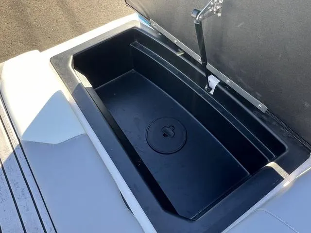 Slide: The Image of 2023 Moomba Max storage compartment with open lid, showcasing spacious interior design. - 15