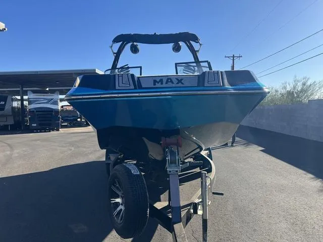 Slide: The Image of 2023 Moomba Max boat on trailer, parked outdoors under clear sky. - 8