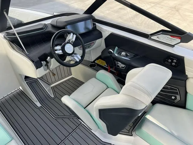 Slide: The Image of Interior of 2023 Nautique Super Air Nautique G25 boat, featuring modern helm and seating. - 10