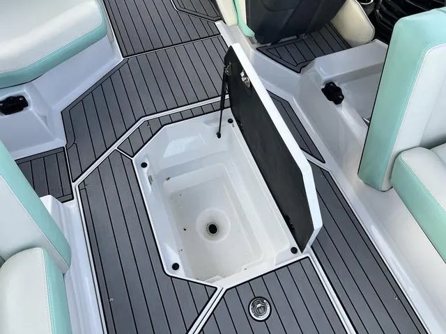 Slide: The Image of 2023 Nautique Super Air Nautique G25 interior with open storage compartment. - 14